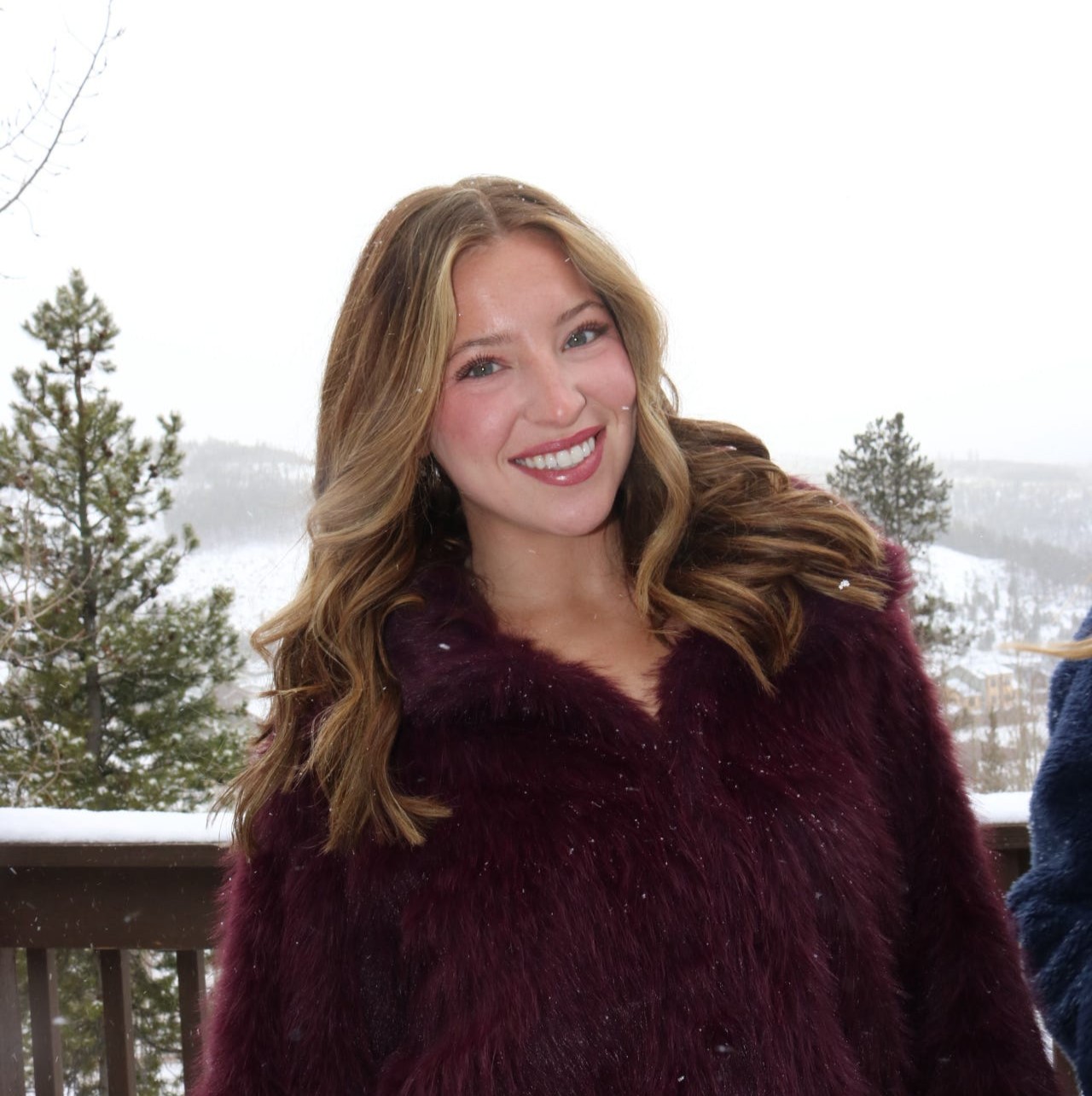 Photo of Abbey smiling in pink fuzzy jacket