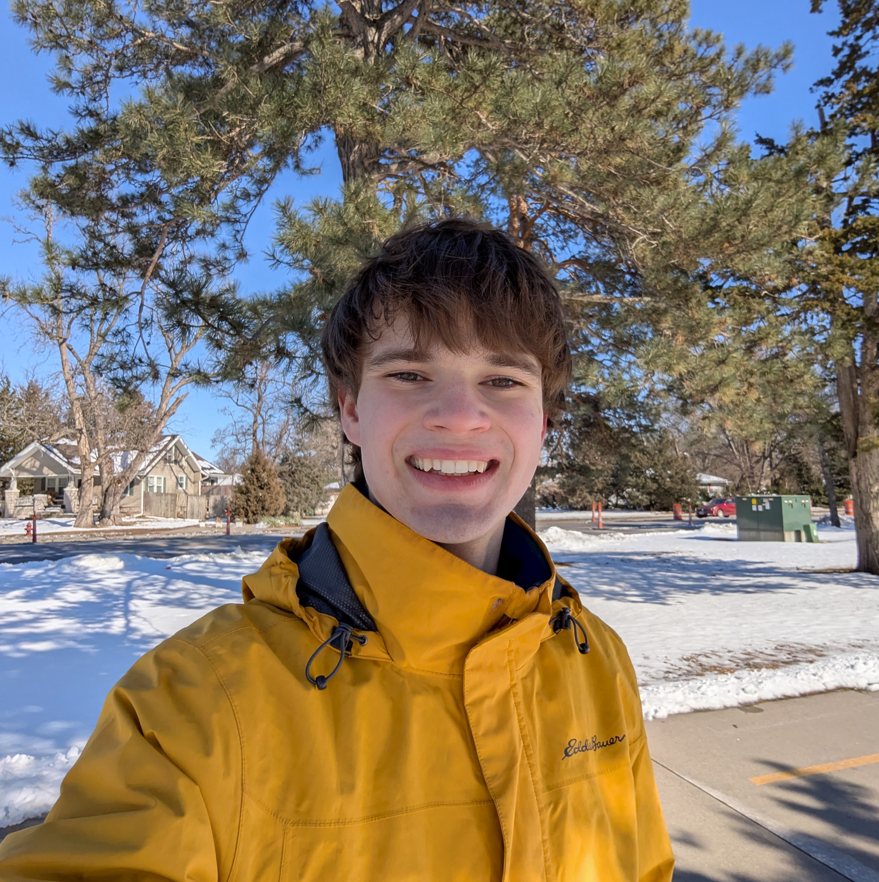Photo of Ben smiling in yellow coat