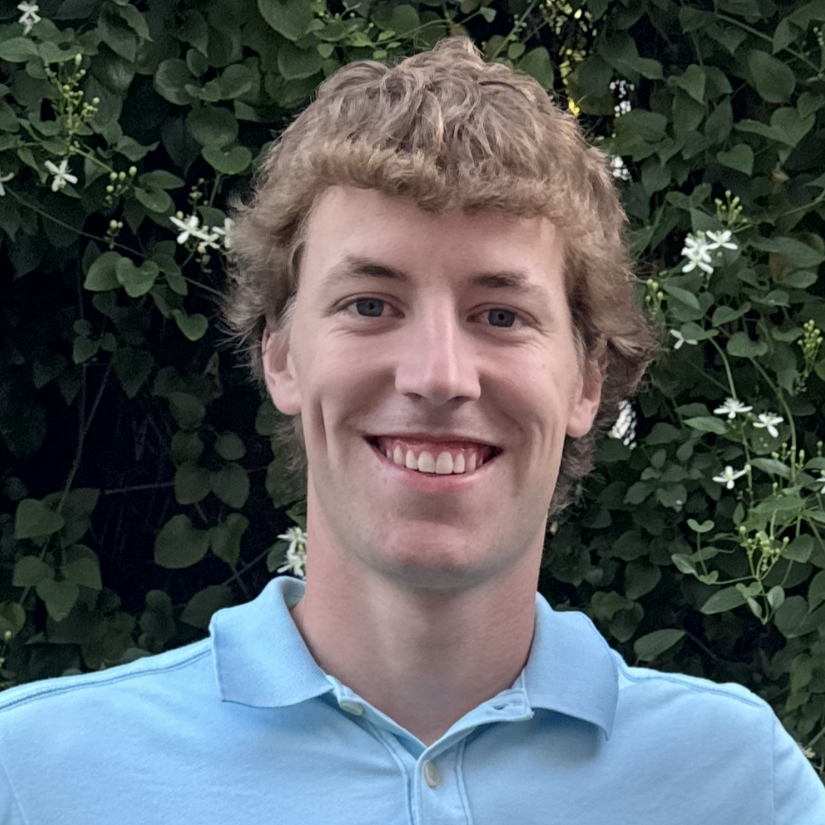 Tommy in blue shirt smiling