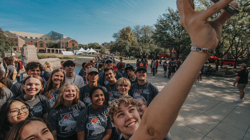 Students standing together on steps. 
