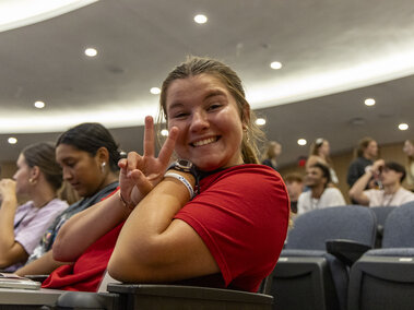 A student holding a peace sign.