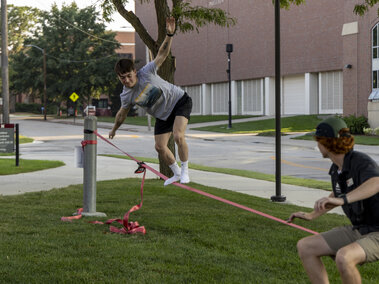 A student balancing on a slackline.