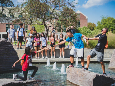 Students standing by the Union fountain posing for a "silly" photo.